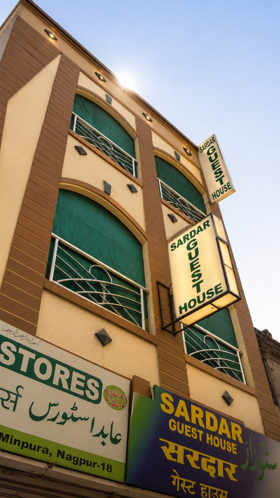 Sardar Guest House signboard and facade with green balcony curtains on Mohammad Ali Road, Mominpura